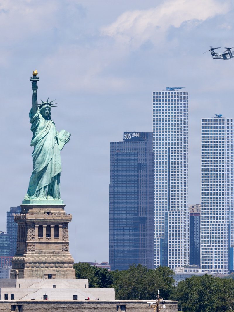 The Statue of Liberty on July 4, 2026, during International Naval Review 250, a Marine Corps Osprey overhead — opens the essay (PDF)